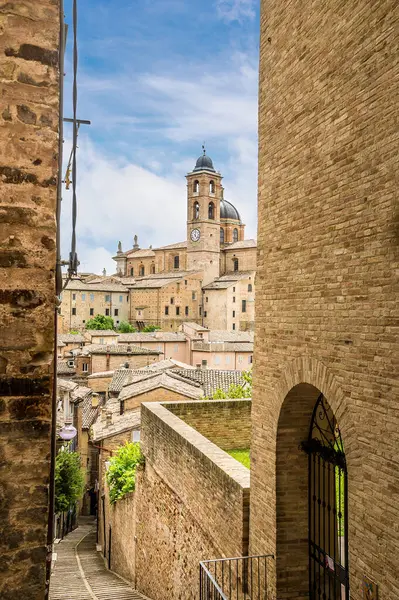 stock image A view down a narrow street towards the center of the city in Urbino, Italy in summertime