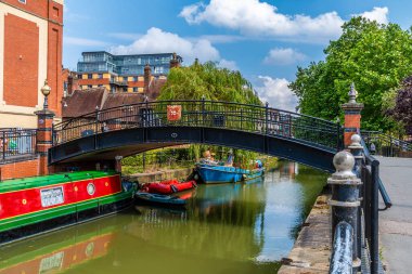 A view of a footbridge over the River Witham in the center of Lincoln, Lincolnshire in summertime clipart