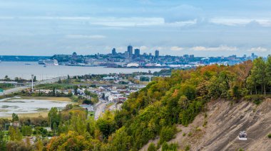 A view towards Quebec City from the Montmorency falls in Canada in the fall clipart