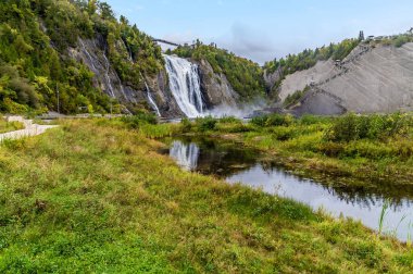 A view down a stream from the regression channel towards the Montmorency falls near Quebec City, Canada in the fal clipart