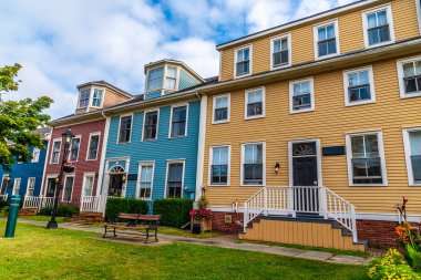 A view down a street of brightly colored buildings in Charlottetown, Prince Edward Island, Canada in the fall clipart