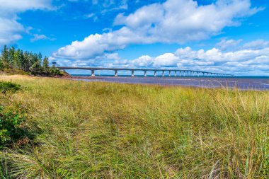 A view across sea grass towards the Confederation bridge, Prince Edward Island, Canada in the fall clipart