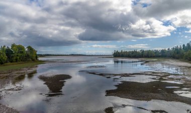 A view across a river tributary at the northern end of the Confederation bridge, Prince Edward Island, Canada in the fall clipart