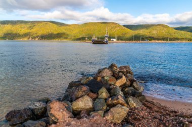 A view from the south shore looking across towards the Englishtown Ferry on the Cabot Trail, Nova Scotia, Canada in the fall clipart