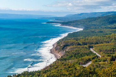 A view along the coastline on the Cabot Trail at Cape Smokey, Nova Scotia, Canada in the fall clipart