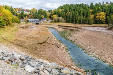 A view towards the Hardscrabble Covered Bridge at Vaughan Creek, New Brunswick in the fall clipart