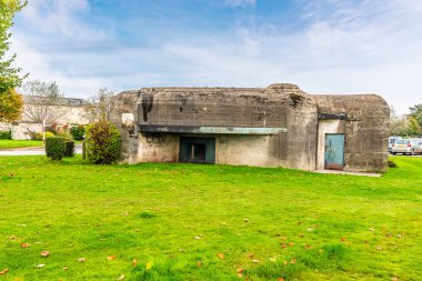 A view towards the opening in a second world war defense bunker in the harbor at Cherbourg, France in autumn clipart