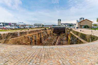 A view across the dry dock beside the middle inner harbor  at Cherbourg, France in autumn clipart