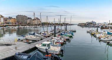 A view out to sea across the middle inner harbor  at Cherbourg, France in autumn clipart