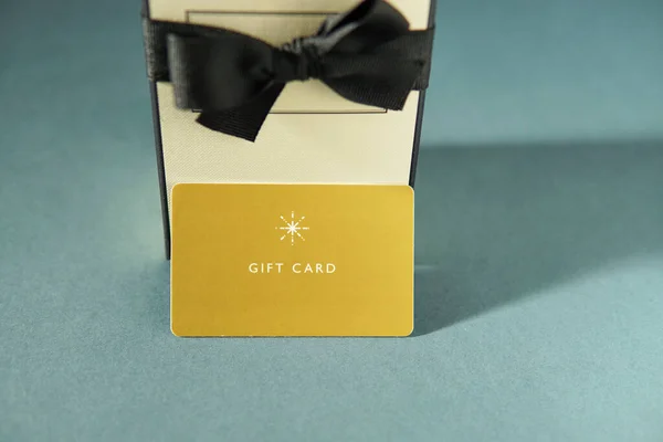 Gelbe Geschenkkarte Und Ein Geschenkkarton Vor Grünem Hintergrund Gutschein Oder — Stockfoto
