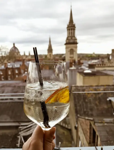 stock image one cocktail sit on a table in Oxford, overlooking the historic city skyline with iconic buildings in the background.