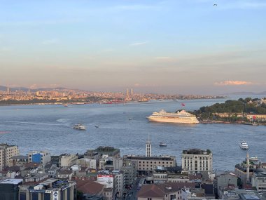 İstanbul, Türkiye - 27 Mayıs 2024: Bu büyüleyici hava fotoğrafı İstanbul 'un canlı şehir manzarasını, Boğaz Nehri' ni ve ikonik simgelerini gözler önüne seriyor. Görüntü, bu tarihi şehrin hareketli atmosferini ve mimari güzelliğini yakalıyor.