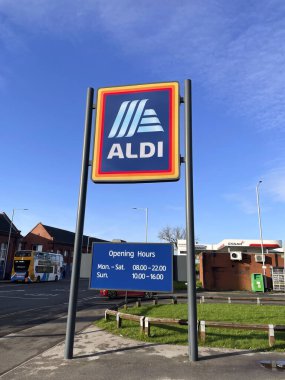 Manchester, UK, Oct 4 2024. Commercial sign of ALDI Store against a blue sky with white cloud. ALDI is the common brand of two German discount supermarket chain. clipart