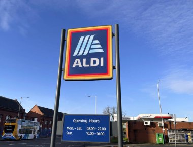 Manchester, UK, Oct 4 2024. Commercial sign of ALDI Store against a blue sky with white cloud. ALDI is the common brand of two German discount supermarket chain. clipart