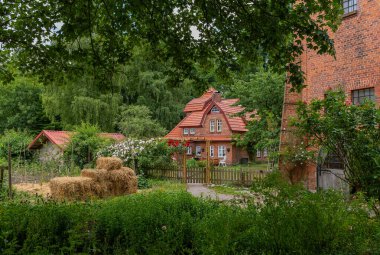 AHRENSBURG, GERMANY-JUNE 24, 2023: Buildings of the Wulfsdorf farm, Ahrensburg near Hamburg clipart