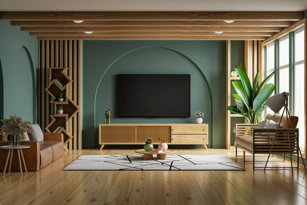 緑の壁とリビングルームの革のソファ付きの木製キャビネットに取り付けられたテレビの壁をモックアップします — ストック写真