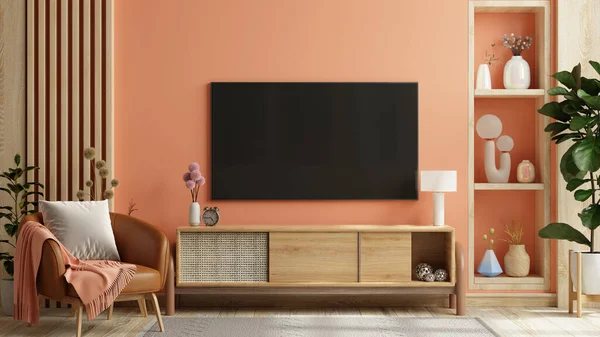 Mockup a TV wall mounted in pastel tone peach fuzz color wall- 3D rendering