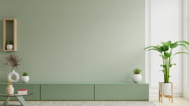 Minimalist oturma odasının iç tarafında televizyon ve yeşil duvarlı dekor aksesuarları için yeşil dolap var.