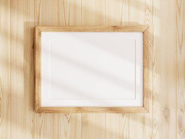 Ahşap döşeme üzerinde ahşap çerçevesi olan boş poster maketi.