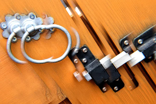 Double wooden driveway gates latch bolt and handle abstract