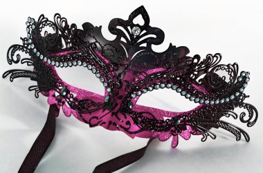 A masquerade eye mask in pink and black isolated on a white background clipart