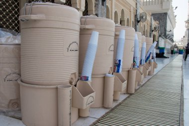 Mecca - Saudi Arabia: August 24, 2018. Zamzam water in plastic drums in The Haram mosque in Mecca clipart