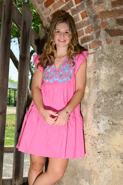 stock image Young pretty teenage girl posing in a historic setting for her high school graduation photos