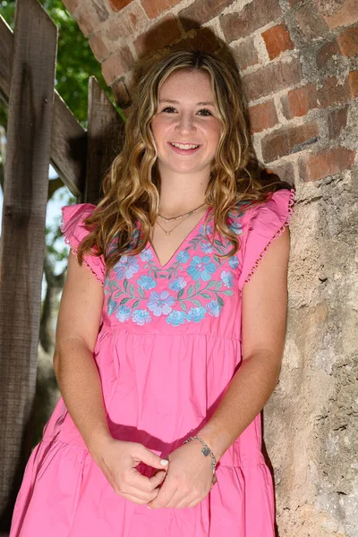 stock image Young pretty teenage girl posing in a historic setting for her high school graduation photos