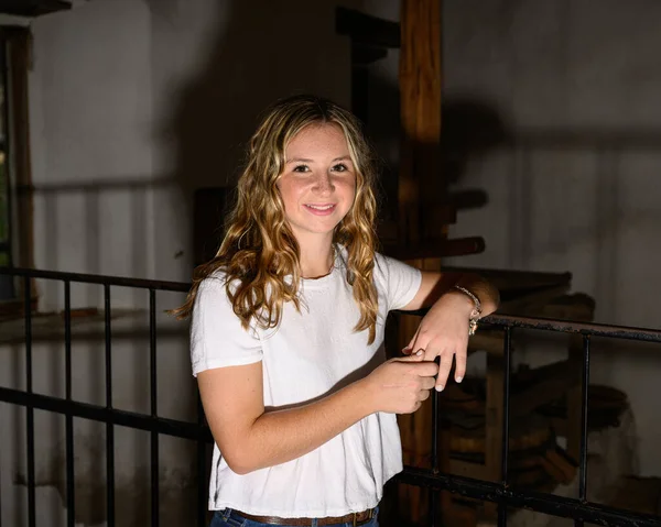 stock image Young pretty teenage girl posing in a historic setting for her high school graduation photos