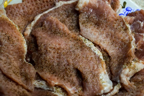 stock image Pork meat with salt and pepper is made for cooking chops on a plate