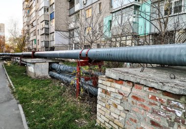 Merkezi bir ısı tedarik borusu kazan dairesinden ısıtma evleri için yüksek katlı binalara gidiyor.