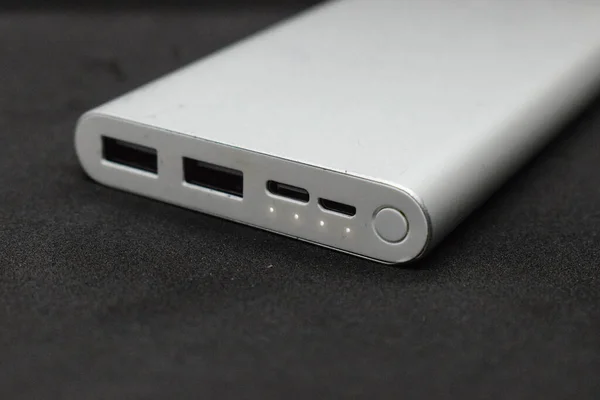 A powerbank for charging mobile devices with on indicators on a white background