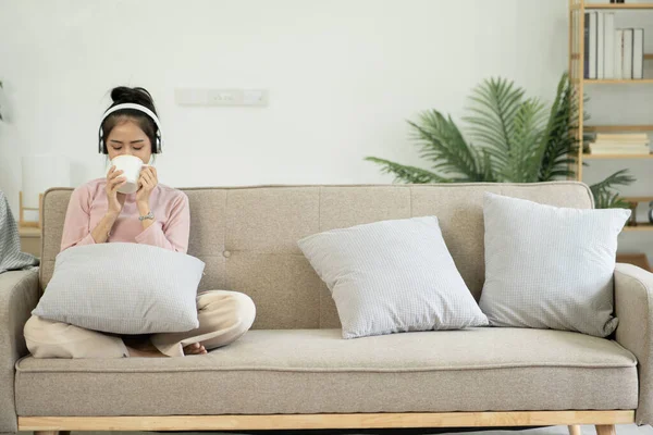 stock image Asian woman watching movies, listening to music, video calling at home.