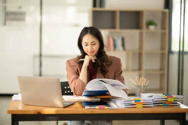 stock image Asian business woman looking at financial documents