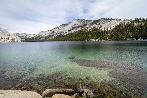 Serenity in nature: Lake, mountains, sky, trees. A captivating and peaceful oasis. May Lake Yosemite National Park California