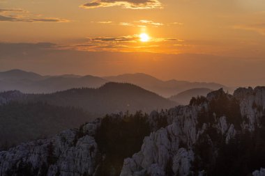 Hırvatistan 'ın Bijele stijene dağlarında güneş doğarken tepelerin siluetinin katmanları