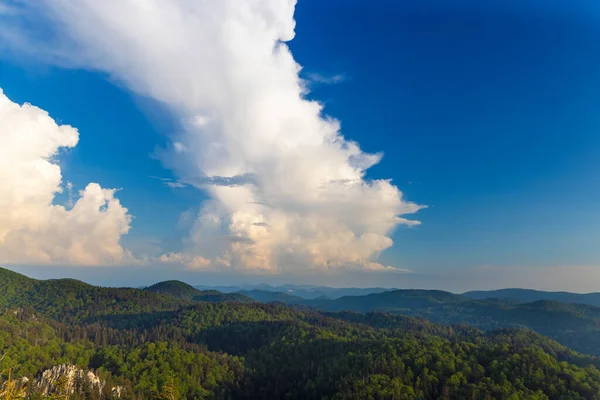 stock image Large clouds above the forested mountains, Bijele stijene reserve in Croatia