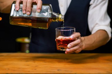 Barmen viski ikram ediyor, ahşap barda.,