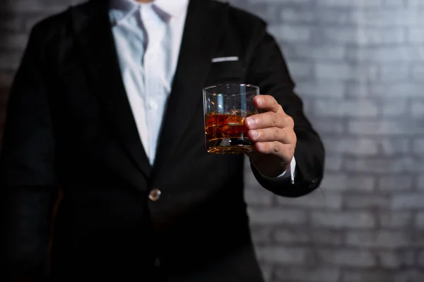 stock image Closeup businessmen holding a glass of whiskey