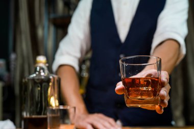 Barmen viski ikram ediyor, ahşap barda.,