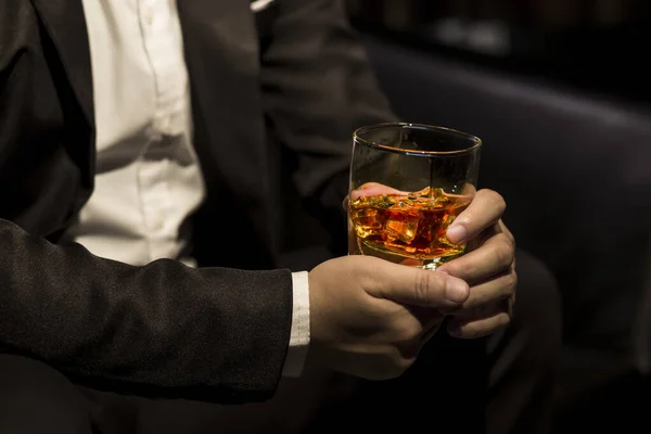 stock image Closeup businessmen holding a glass of whiskey