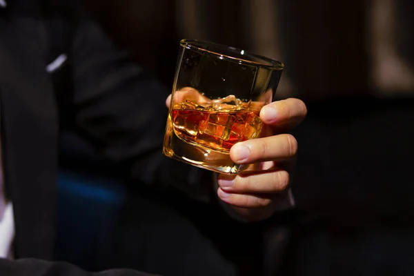 stock image Closeup businessmen holding a glass of whiskey