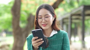  Ofis dışındayken Asyalı iş kadınının cep telefonu kullanması, mesajlaşması ve aldatması..