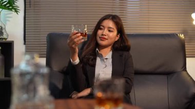 Closeup business woman holding a glass of whiskey