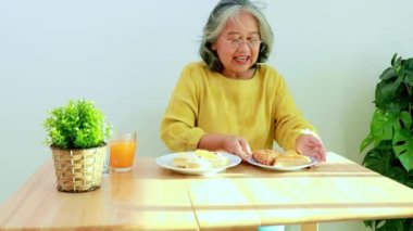 Elderly asian women who avoid  snack sweets containing too much sugar and starch in cakes and pineapple pies decide refuse not to eat them : Elderly women health care concept