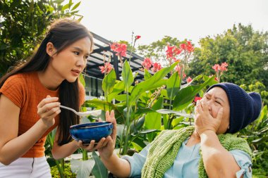 Kanser hastası olan, vücudu ve sağlığı yerine gelsin diye çorba içen ama yemekten sıkılan bir anne, sağlıklı beslenmek istemeyen ve yiyemeyen yaşlı bir anneye bakıyor.