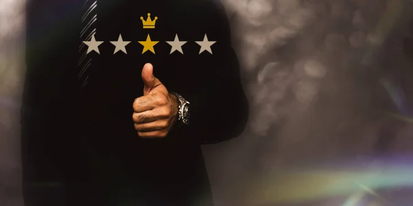Businessman thumb up pointing at positive five star : Performance appraisal Provide quality grade ratings to ensure successful work satisfaction concept