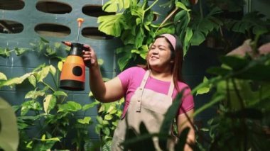 Hobby in the fat woman's house good mood planting trees in front of the house caring loving trees keeping the house shady watering the trees being happy planting green plants small botanical garden.