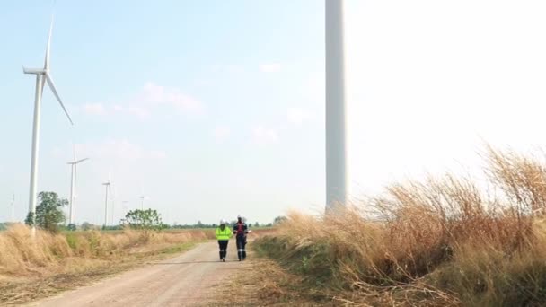 Teamwork Two Caucasian Technicians Inspect Stands Analyzing Wind Power Station — 图库视频影像