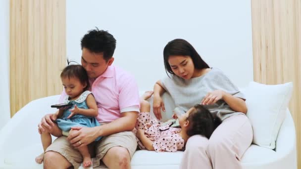 Happy Asian Family Parents Sit Look Petulant Little Daughter Sofa — Stock Video